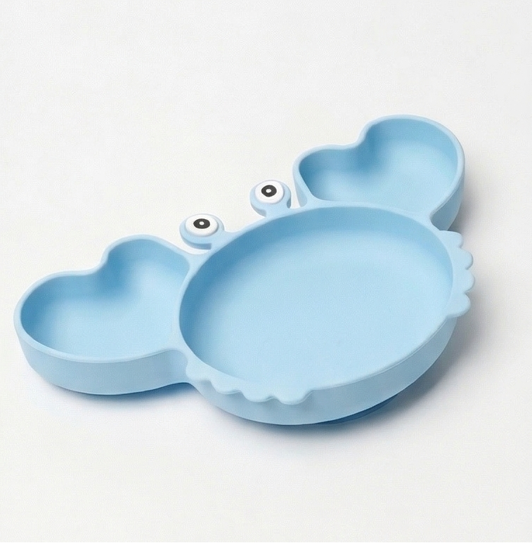 Light blue crab shaped silicone feeding plate on a white background